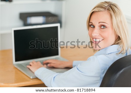 Gorgeous businesswoman looking into camera in her office