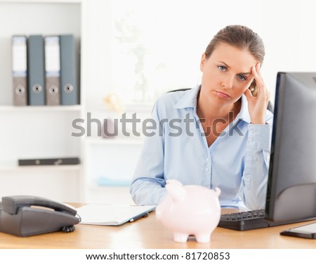 Depressed working woman posing in her office