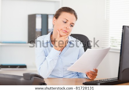 Brunette businesswoman thinking about a strategy in her office