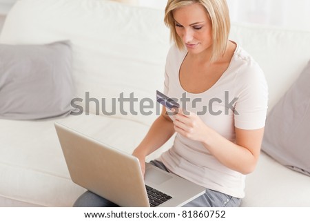 Close up of a woman shopping on line in her living room
