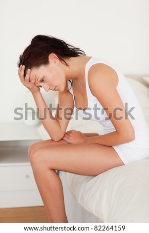 Woman not feeling well in her bedroom