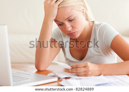 Worn out woman accounting in the living room