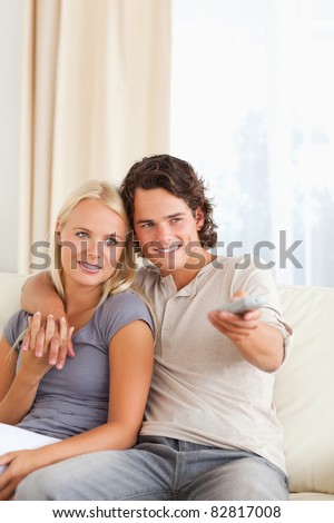 Portrait of a couple watching TV in their living room