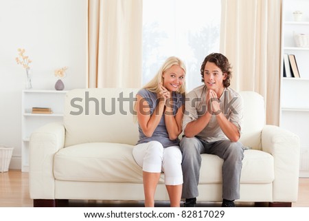 Couple watching a game on TV in their living room