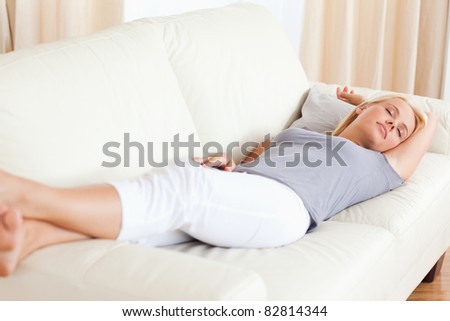 Woman sleeping on a couch in her living room