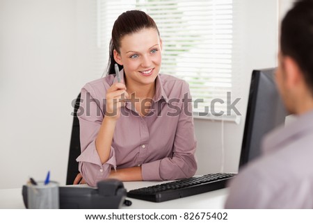 A businesswoman listens to a customer