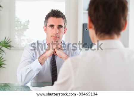 Handsome manager interviewing an applicant in his office