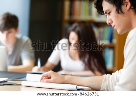 Students working on a paper with the camera focus on the foreground
