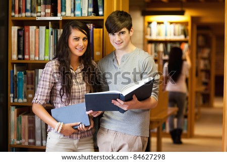 Smart students with a book in a library