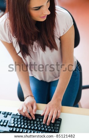 Portrait of a student using a keyboard while looking away from the camera