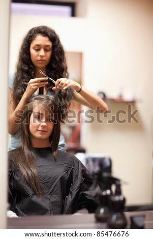 Portrait of a woman having a haircut while looking at the camera