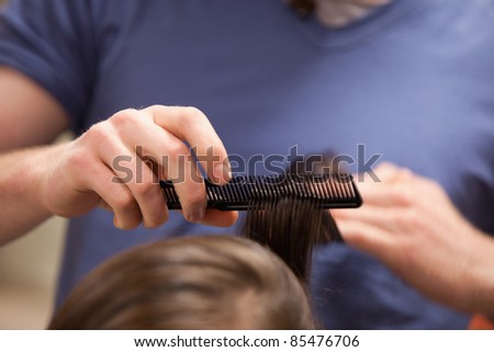 Hand combing hair with a comb