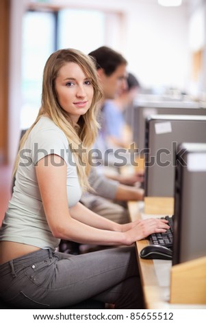 Portrait of a blonde student using a computer in an IT room