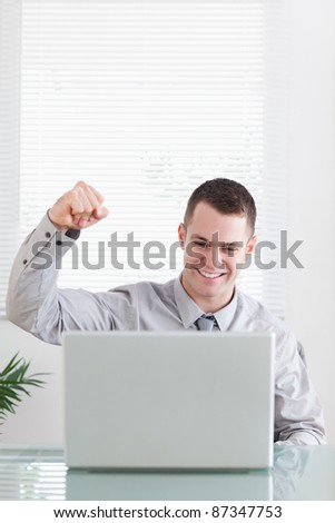 Close up of young businessman happy about an email