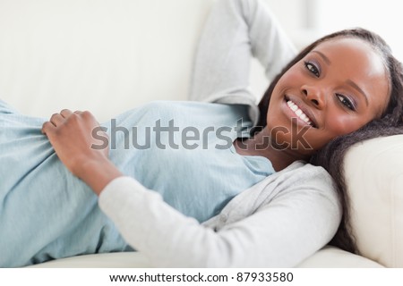 Close up of smiling woman taking a break on the sofa
