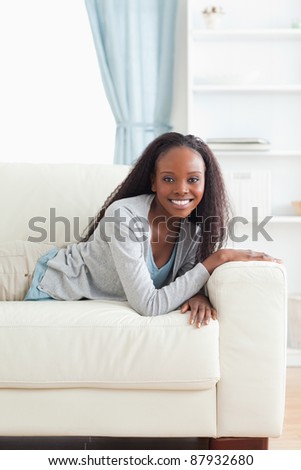 Smiling woman taking a small break on the sofa