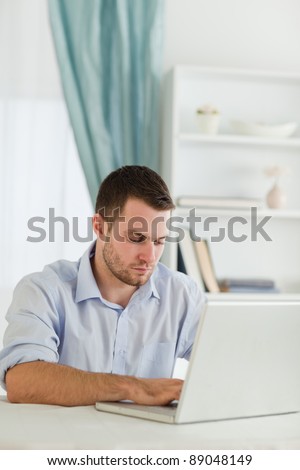 Young businessman with rolled up sleeves working on his laptop
