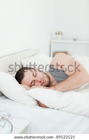Portrait of a young man sleeping in his bedroom