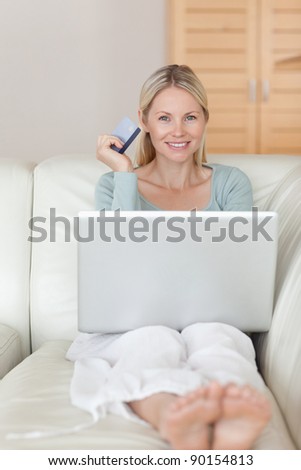 Smiling young woman shopping online