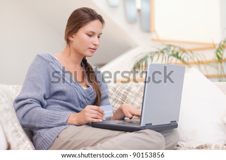 Woman shopping online in her living room
