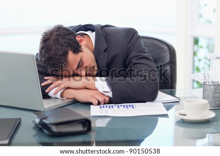 Tired businessman sleeping in his office