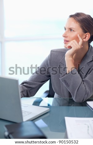 Portrait of a doubtful businesswoman working with a laptop in her office
