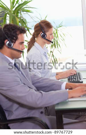 Young call center agents working next to each other