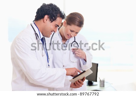 Young medical assistants looking at clip board