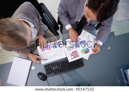 Business team looking at statistics in a meeting room