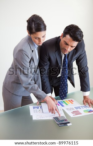 Portrait of focused sales persons studying their results in an office
