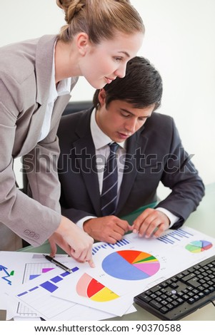 Portrait of a serious business team studying statistics with a computer in a meeting room