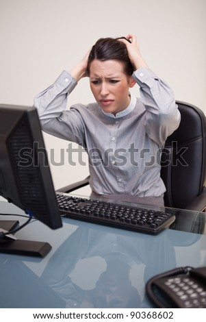 Young businesswoman having problems with her computer