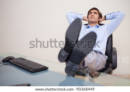 Young businessman leaning back in his chair