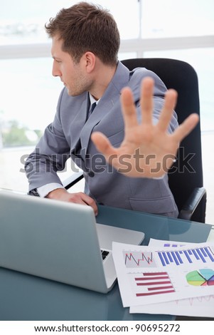 Businessman at his desk does not want to listen