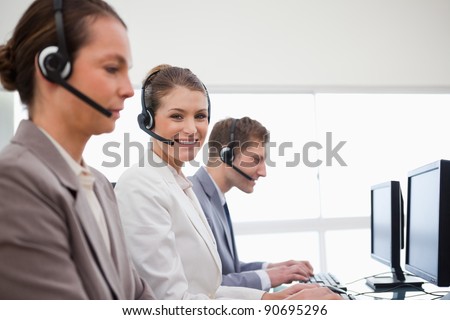 Side view of telephone service office employees at work