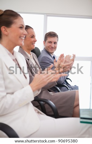 Side view of business team applauding after a presentation