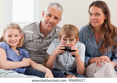 Charming family playing video games in a living room