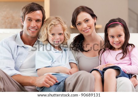 Happy family watching television together in a living room