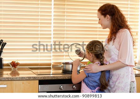 Mother and daughter cooking a meal together