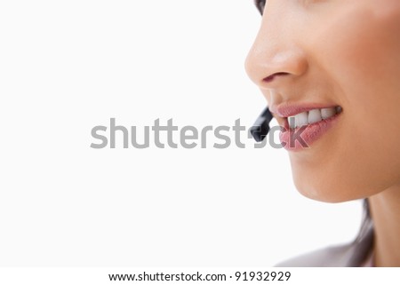 Side view of talking mouth of female call center agent against a white background