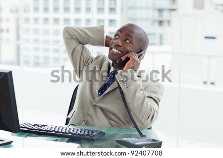 Office worker on the phone looking away from the camera
