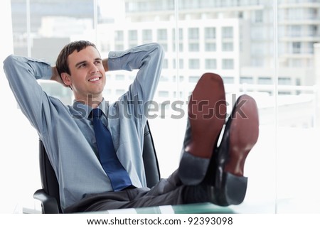 Happy manager relaxing in his office