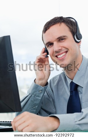 Portrait of an office worker using a headset in his office