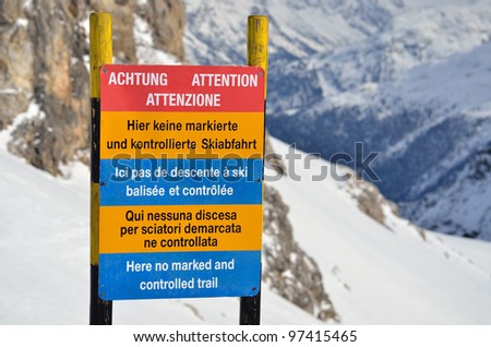 Warning informational sign on the ski slope in mountains -\
