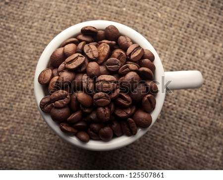 coffee cup with roasted beans. top view.