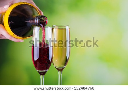 Woman pouring red wine into glass