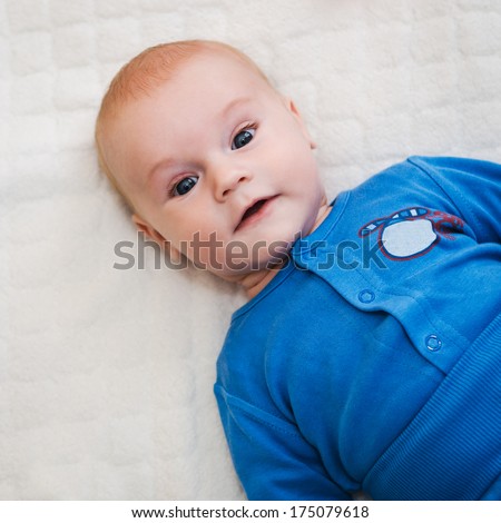 Beautiful smiling baby on soft cover
