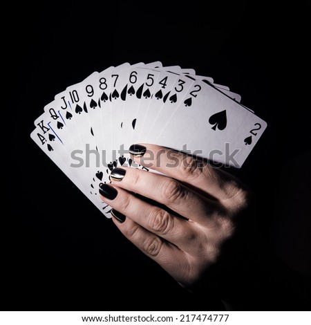 poker cards in hand on dark background