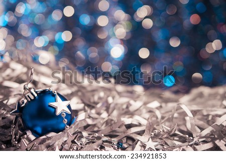 Christmas blue ball with star on background