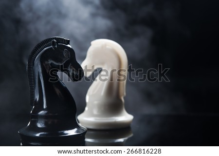 Chess pieces knight on dark background